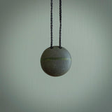 A drop pendant made from Onewa Stone - New Zealand Greywacke - with a fine Pounamu insert spliced into the middle.