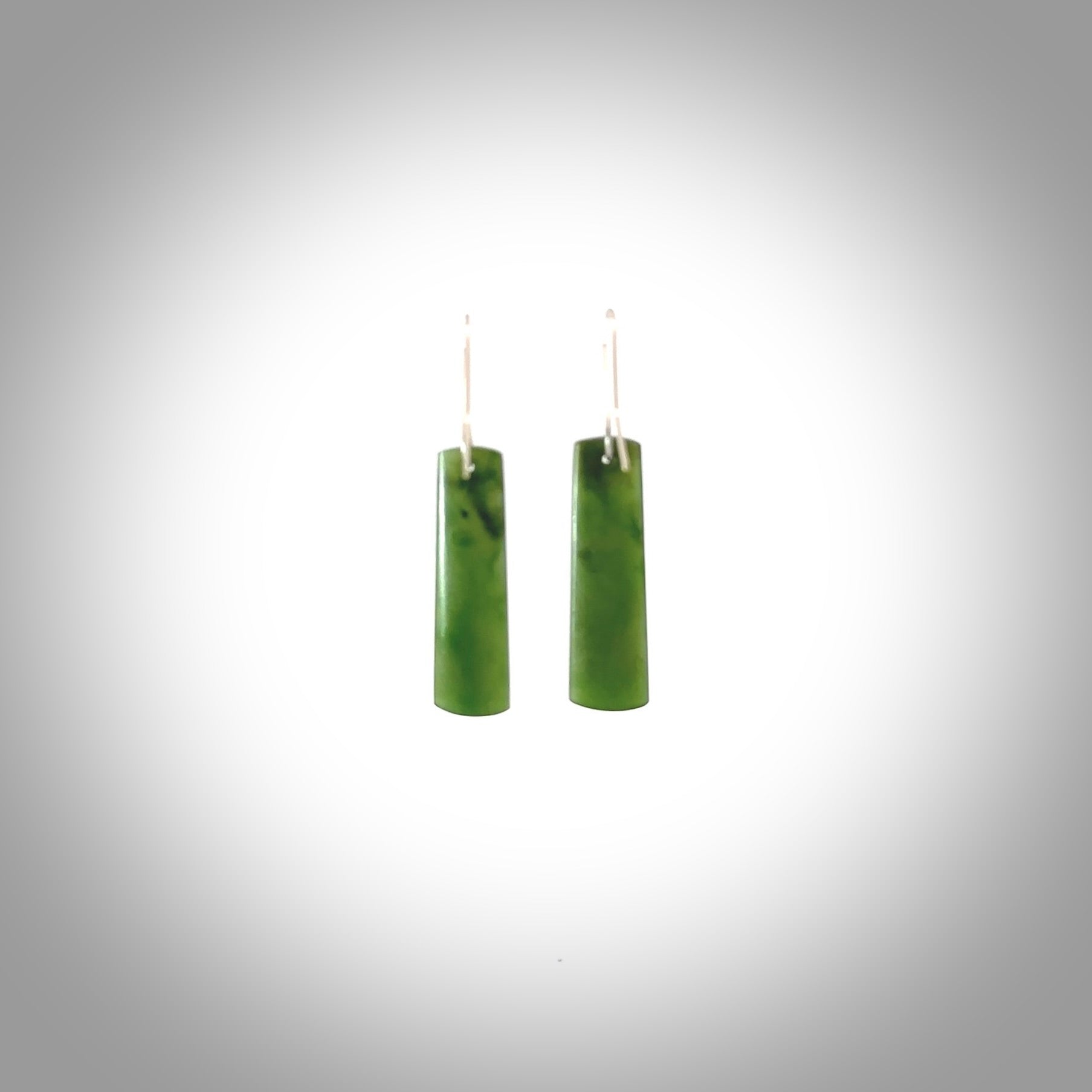 These are stunning medium-large drop shaped jade earrings carved in New Zealand by Darren Hill. It is carved from a semi-translucent light green piece of New Zealand Jade and with Sterling Silver hooks.