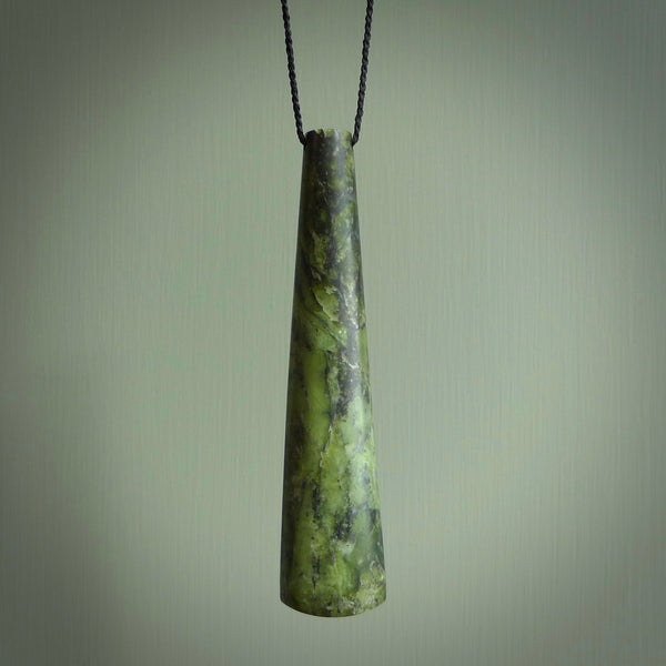 This photo shows a large jade drop shaped pendant. It a a lovely, colourful flower jade. The cord is a four plait black and is adjustable in length. One only large, contemporary drop necklace from Jade, by Rueben Tipene.