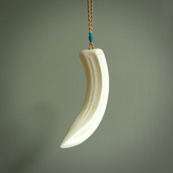 Hand carved whale pendant, carved by us. This piece is carved from boars tusk and is a fantastic depiction of these giants of the deep. This particular piece is a whale design and is lovingly carved.