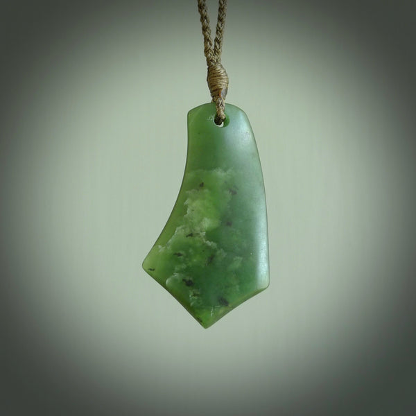 This picture shows a medium sized hand carved jade drop pendant by Ric Moor. The jade is a wonderful deep green. It is suspended from a khaki adjustable cord. Delivery is free worldwide.
