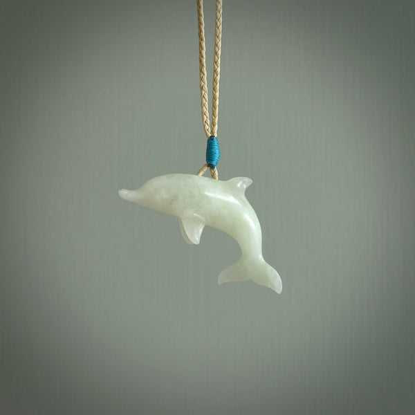 This is a gorgeous little dolphin pendant carved in jadeite. The cord is fine, hand-plaited and length adjustable so you can position the little jade dolphin where it suits you best. Shipping is free worldwide.