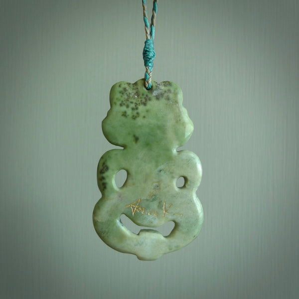 This is a large sized tiki - carved from gorgeous Marsden jade. The craftsmanship is superb, this piece is as well carved as any we have seen. The cord is an adjustable four plaited cord in black. One only by Ana Krakosky.