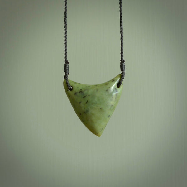 This is a lovely New Zealand Jade, pounamu drop pendant. Hand carved for us by Ric Moor. It is bound with an adjustable black coloured cord which is length adjustable. Free worldwide shipping.