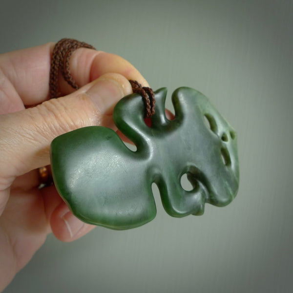 This is a large sized tiki - carved from gorgeous Marsden jade with Pāua Shell eyes. The craftsmanship is superb, this piece is as well carved as any we have seen. We have plaited an adjustable brown cord for this piece. 