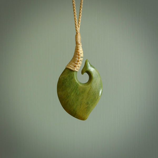 This matau, is carved from a very striking New Zealand jade. It is both intricate and simple in design - it has hidden folds and smooth curves. A piece to be worn or displayed - the carving and the jade are both magnificent. Hand made by Donna Summers.