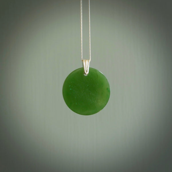 Hand made small British Columbian circle, drop pendant. Hand carved in New Zealand by Kerry Thompson. Hand made jewellery. Unique British Columbian Jade round drop pendant with sterling silver chain. Free shipping worldwide.