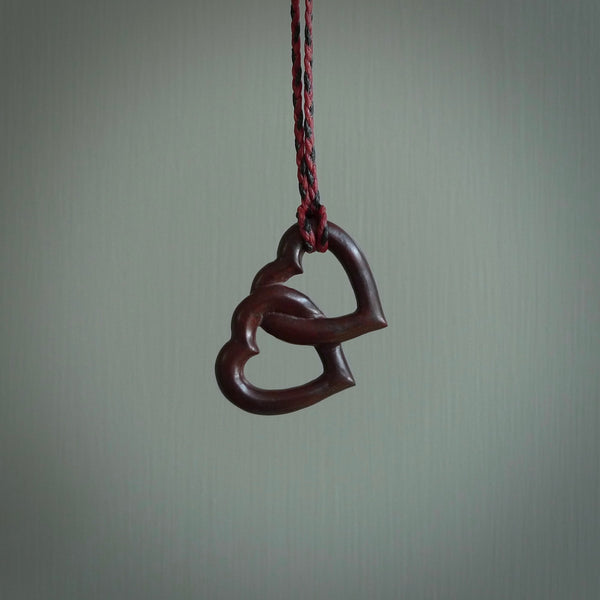 Hand carved double heart pendant made in black jade, green jade and jasper stone. Made by NZ Pacific. Carved from green jade, black jade and red jasper stone. Free delivery worldwide.