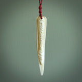 This is a hand carved deer antler taiaha pendant. It is made from deer antler, bone. This is a large sized necklace and is a very unique, one only, pendant that is a wonderful piece. Hand carved deer antler taiaha necklace for men and women.