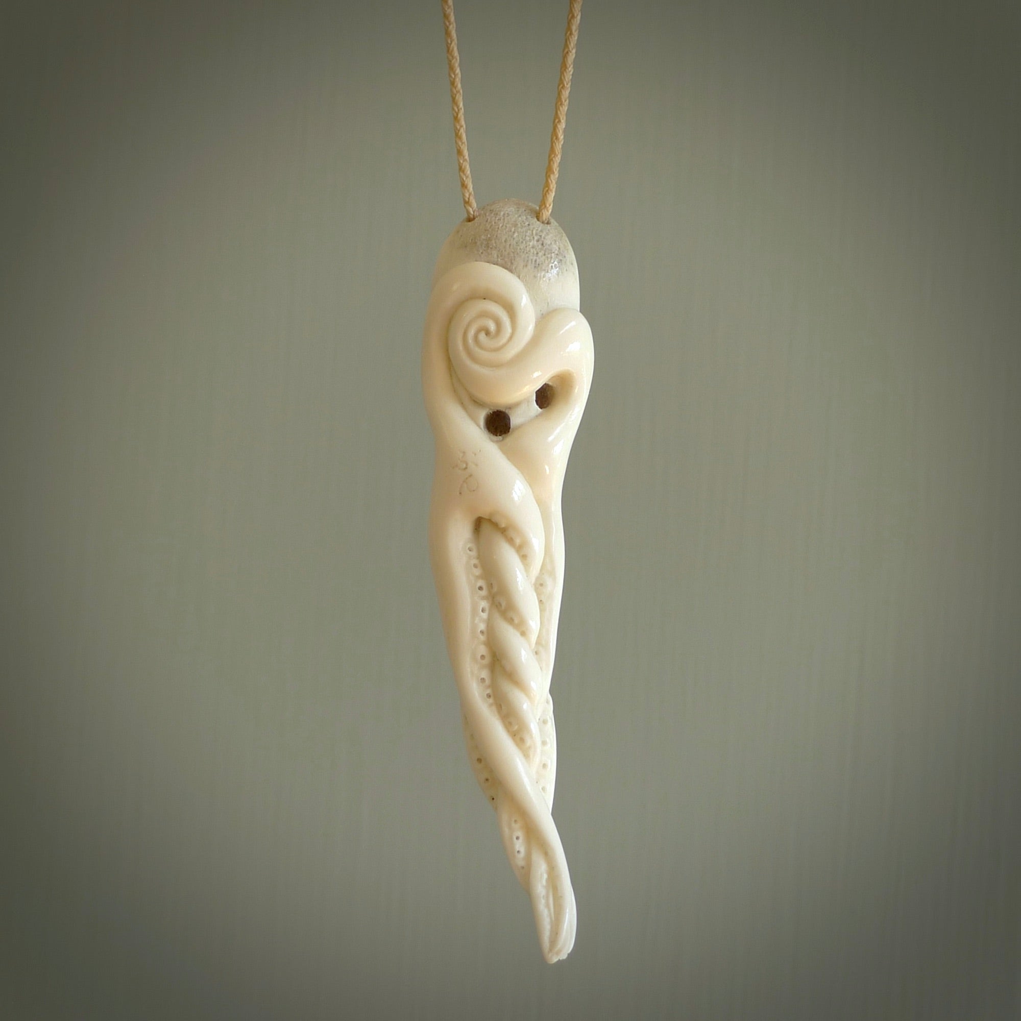 Hand carved octopus pendant in resting pose. This piece has been carved in incredible detail from bone. The artist is Fumio Noguchi, a renowned New Zealand bone carver who carves pieces for NZ Pacific. These unique bone pendants are for sale online at nzpacific.com One only collectors item for lovers of the ocean and octopus.