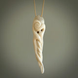 Hand carved octopus pendant in resting pose. This piece has been carved in incredible detail from bone. The artist is Fumio Noguchi, a renowned New Zealand bone carver who carves pieces for NZ Pacific. These unique bone pendants are for sale online at nzpacific.com One only collectors item for lovers of the ocean and octopus.