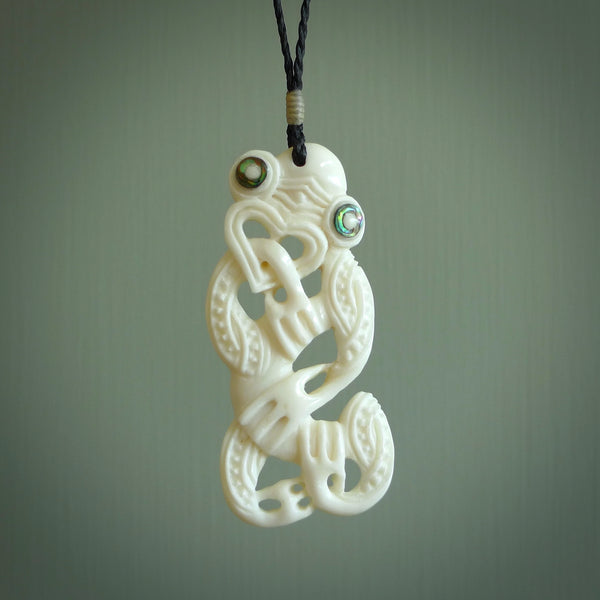 Hand carved bone Tiki pendant. Traditional art hand carved for NZ Pacific. Bone Tiki necklace with Paua Shell eyes.