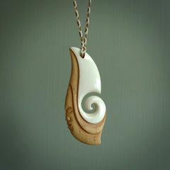 A hand carved bone contemporary, intricate pendant. The cord is a 4 strand, 3 plait in Ice White and Tan and is an adjustable length. A large sized hand made contemporary necklace by New Zealand artist Kerry Thompson. Kerry has stained parts of the bone which really add to the dimension of this pendant. One of work of art to wear.