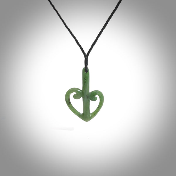 This is a beautiful koru pendant designed with a little inspiration from our national airline, Air New Zealand. It is carved from green jade which we source in Aceh and it is a lovely bright green with some dark speckled inclusions. A wonderful pendant.