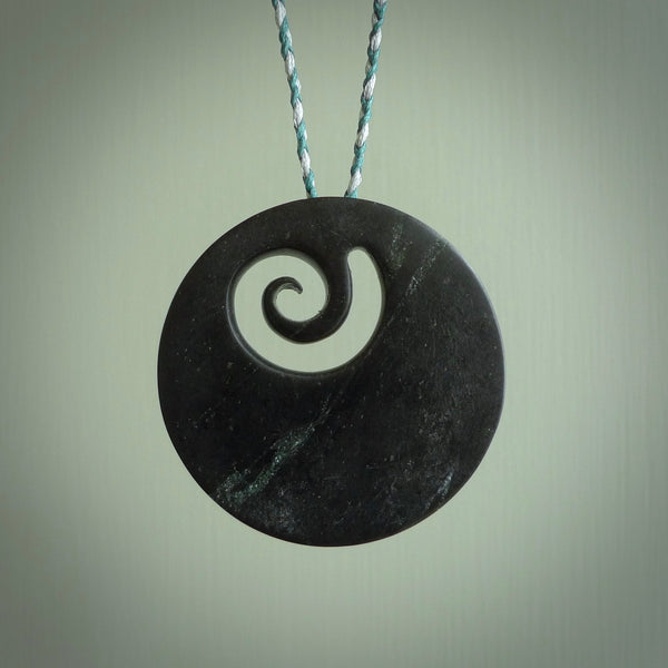 Hand made large New Zealand Pounamu, Jade Koru pendant. Hand carved in New Zealand by Rueben Tipene. Hand made jewellery. Unique large Greenstone Koru with adjustable cobalt blue/maui blue cord. Free shipping worldwide.