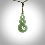 A beautiful carved, complex triple twist pendant. This piece has been carved for us by Ross Crump and is a truly beautiful carving made from some of our finest and rarest flower jade. We will ship this to you with an express courier so you will have it quickly. A rare and beautiful work of wearable art from NZ Pacific.