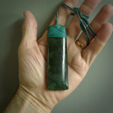 A large and beautiful hand carved toki pendant. This piece is carved from New Zealand jade by NZ Pacific. This is a wonderful large toki bound with a hand-plaited silver and blue cord and a traditional blue lashing. A beautiful, traditional toki for sale online.