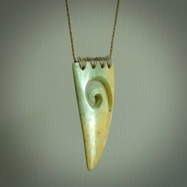 Hand carved New Zealand Flower jade niho, fang, pendant with Koru heart centre. Carved by New Zealand artist Ric Moor. Contemporary New Zealand Jade fang, drop necklace with Koru centre. One only unique pendant for men and women.