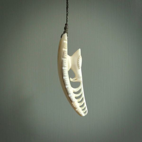 This is a hand carved bone contemporary warthog tusk pendant. Yuri Terenyi has carved this from warthog tusk. It is a delightful, large and artistic piece of jewellery. One only necklace.