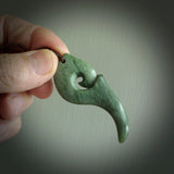 Hand carved huia bird skull made from New Zealand Marsden Jade pendant. Carved for NZ Pacific by Kyohei Noguchi. This is a contemporary piece of jewellery that is carved with intricate detail and clearly shows a beautiful bird skull. We ship this free worldwide with DHL Express Courier.