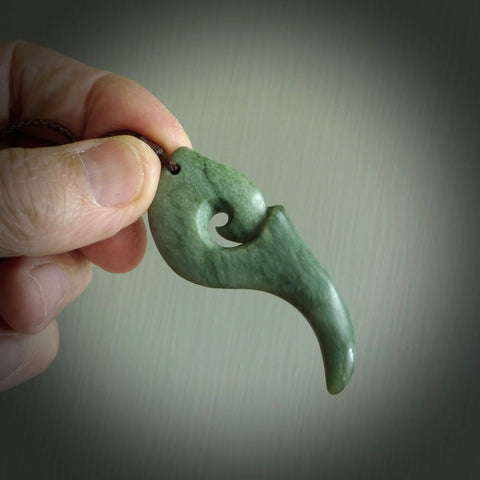 Hand carved huia bird skull made from New Zealand Marsden Jade pendant. Carved for NZ Pacific by Kyohei Noguchi. This is a contemporary piece of jewellery that is carved with intricate detail and clearly shows a beautiful bird skull. We ship this free worldwide with DHL Express Courier.