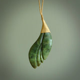 This is a unique flower pendant, hand carved from New Zealand Jade. The cord is a creme colour and is length adjustable. This is delivered to you with Express Courier. Hand carved Jade necklace replicating a flower blossom from Donna Summers.