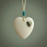 HAND CARVED HEART PENDANT. CARVED FROM BONE. PAUA HEART INSERT. HAND MADE BY NZ PACIFIC. HANDMADE JEWELLERY FOR SALE ONLINE.