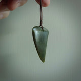 This is a lovely New Zealand Jade, pounamu drop pendant. Hand carved for us by Ric Moor. It is bound with an adjustable brown coloured cord which is length adjustable. Free worldwide shipping.