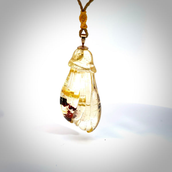 This pendant is handcrafted from rare Kauri Gum Amber. We supply this with a sterling silver chain or an adjustable cord. It is a graceful and very interesting piece that will attract admiration and comment. Hand carved here in New Zealand. Kauri Gum kowhai flower necklace.