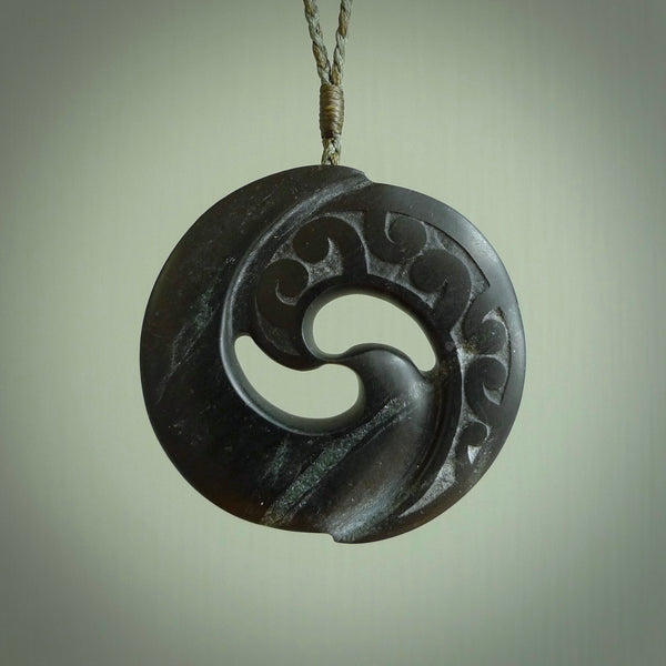 Hand made large New Zealand Pounamu, Jade Koru pendant. Hand carved in New Zealand by Rueben Tipene. Hand made jewellery. Unique large Greenstone Koru with adjustable cord. Free shipping worldwide.