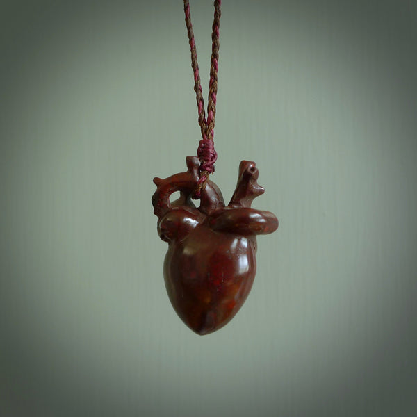 This pendant is handcrafted from Red Jasper Stone. It replicates a human heart. It is supplied with an adjustable burgundy/brown cord. It is a graceful and very interesting piece that will attract admiration and comment. Free Express Shipping.