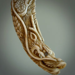 Hand carved dragon Pendant. Made from warthog tusk in New Zealand. Unique dragon necklace hand made from warthog tusk by master bone carver Fumio Noguchi. Spectacular collectable work of art, made to wear. One only pendant, delivered to you at no extra cost with express courier.