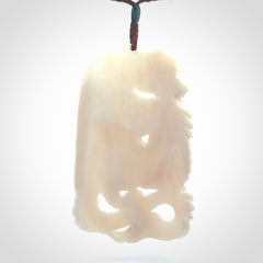 This is a hand carved bone dragon pendant. It is made from bone and has an adjustable Plum coloured cord. This is a large sized necklace and is a very unique, one only, pendant that is a piece for art lovers.