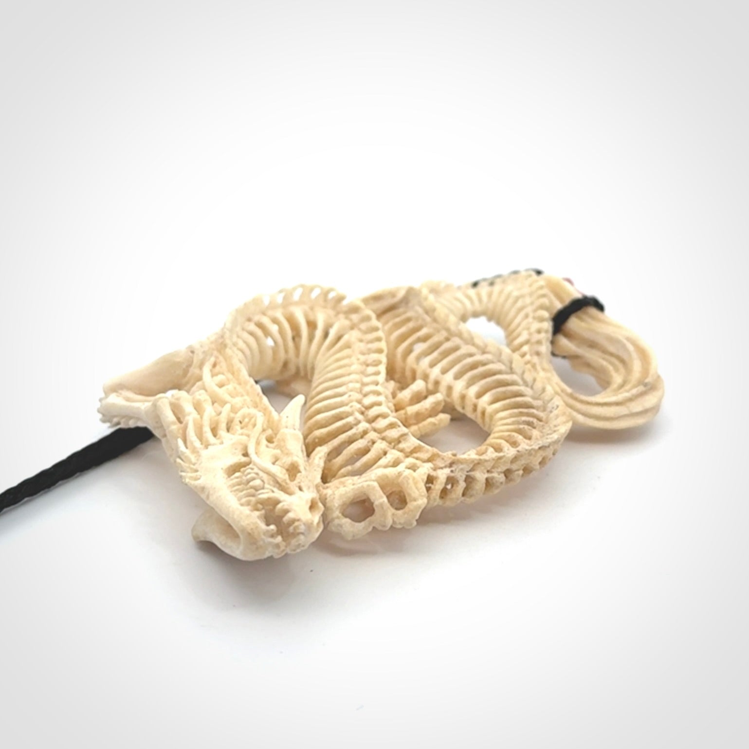 Hand carved incredible dragon Bone carving. A stunning work of art, beautifully replicating a dragon skeleton. This pendant was hand carved in bone and is a one off collectors item that has been hand crafted to be worn or displayed.