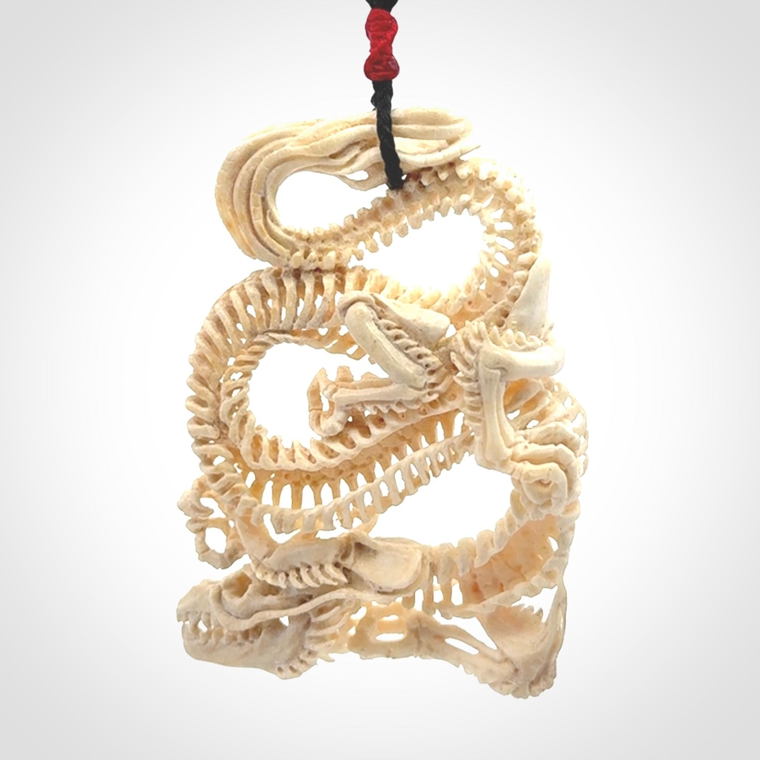 Hand carved incredible dragon Bone carving. A stunning work of art, beautifully replicating a dragon skeleton. This pendant was hand carved in bone and is a one off collectors item that has been hand crafted to be worn or displayed.