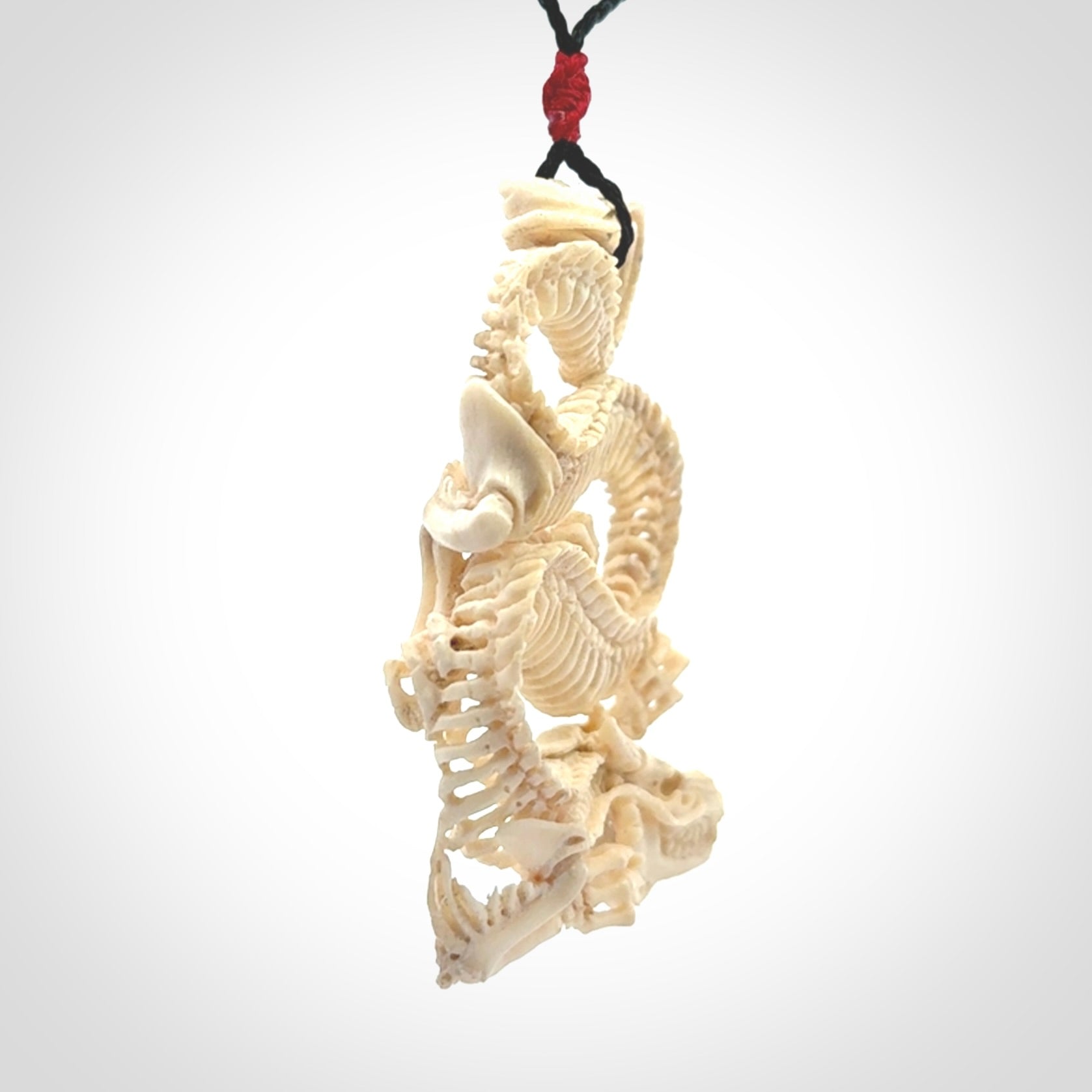 Hand carved incredible dragon Bone carving. A stunning work of art, beautifully replicating a dragon skeleton. This pendant was hand carved in bone and is a one off collectors item that has been hand crafted to be worn or displayed.