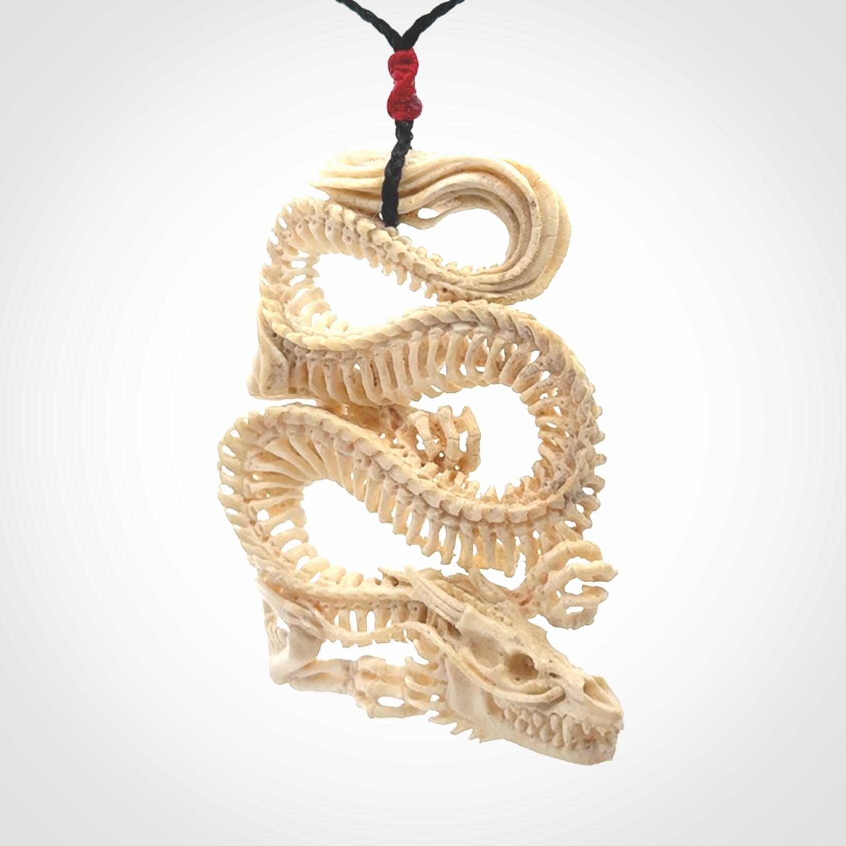 Hand carved incredible dragon Bone carving. A stunning work of art, beautifully replicating a dragon skeleton. This pendant was hand carved in bone and is a one off collectors item that has been hand crafted to be worn or displayed.