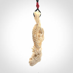 Hand carved incredible dragon Bone carving. A stunning work of art, beautifully replicating a dragon skeleton. This pendant was hand carved in bone and is a one off collectors item that has been hand crafted to be worn or displayed.