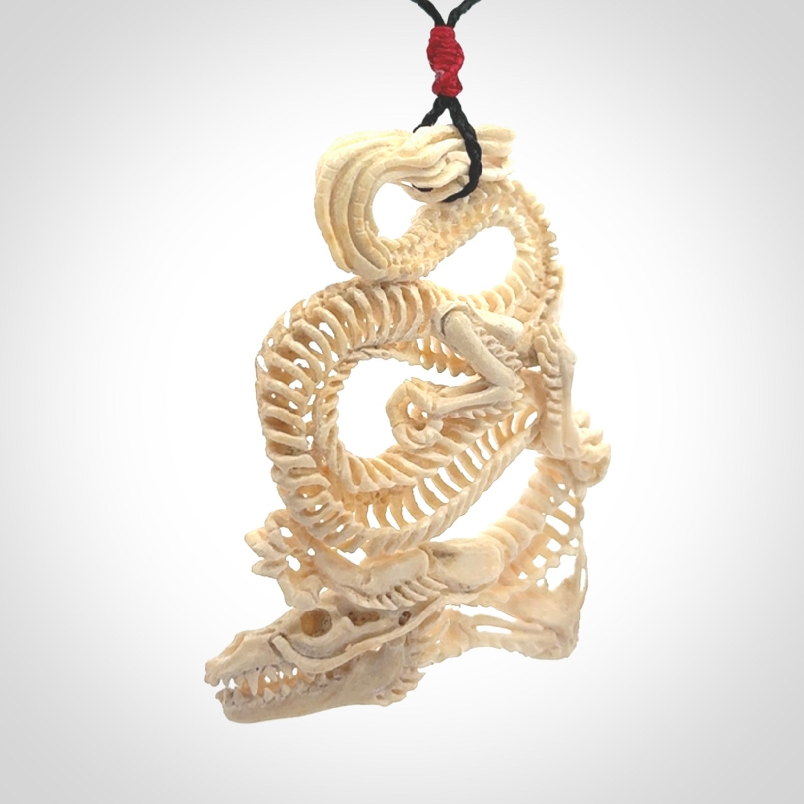 Hand carved incredible dragon Bone carving. A stunning work of art, beautifully replicating a dragon skeleton. This pendant was hand carved in bone and is a one off collectors item that has been hand crafted to be worn or displayed.