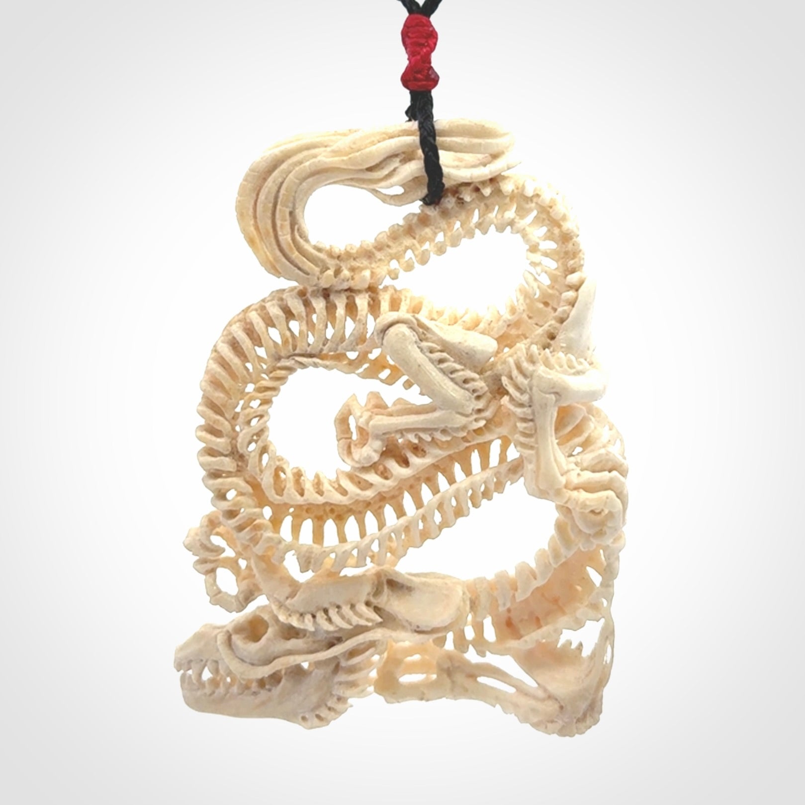 Hand carved incredible dragon Bone carving. A stunning work of art, beautifully replicating a dragon skeleton. This pendant was hand carved in bone and is a one off collectors item that has been hand crafted to be worn or displayed.