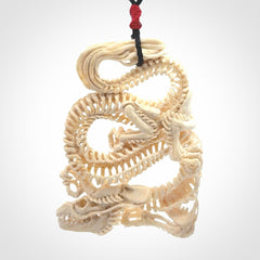 Hand carved incredible dragon Bone carving. A stunning work of art, beautifully replicating a dragon skeleton. This pendant was hand carved in bone and is a one off collectors item that has been hand crafted to be worn or displayed.