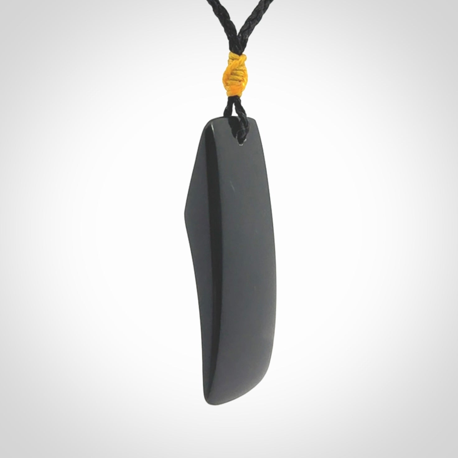 Black Jade toki pendant with bone flower. We've bound it with an adjustable black cord and yellow floret.