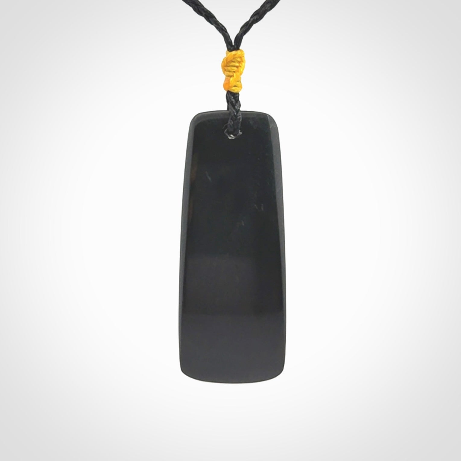 Black Jade toki pendant with bone flower. We've bound it with an adjustable black cord and yellow floret.