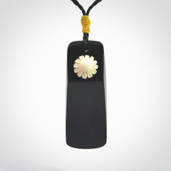 Black Jade toki pendant with bone flower. We've bound it with an adjustable black cord and yellow floret.