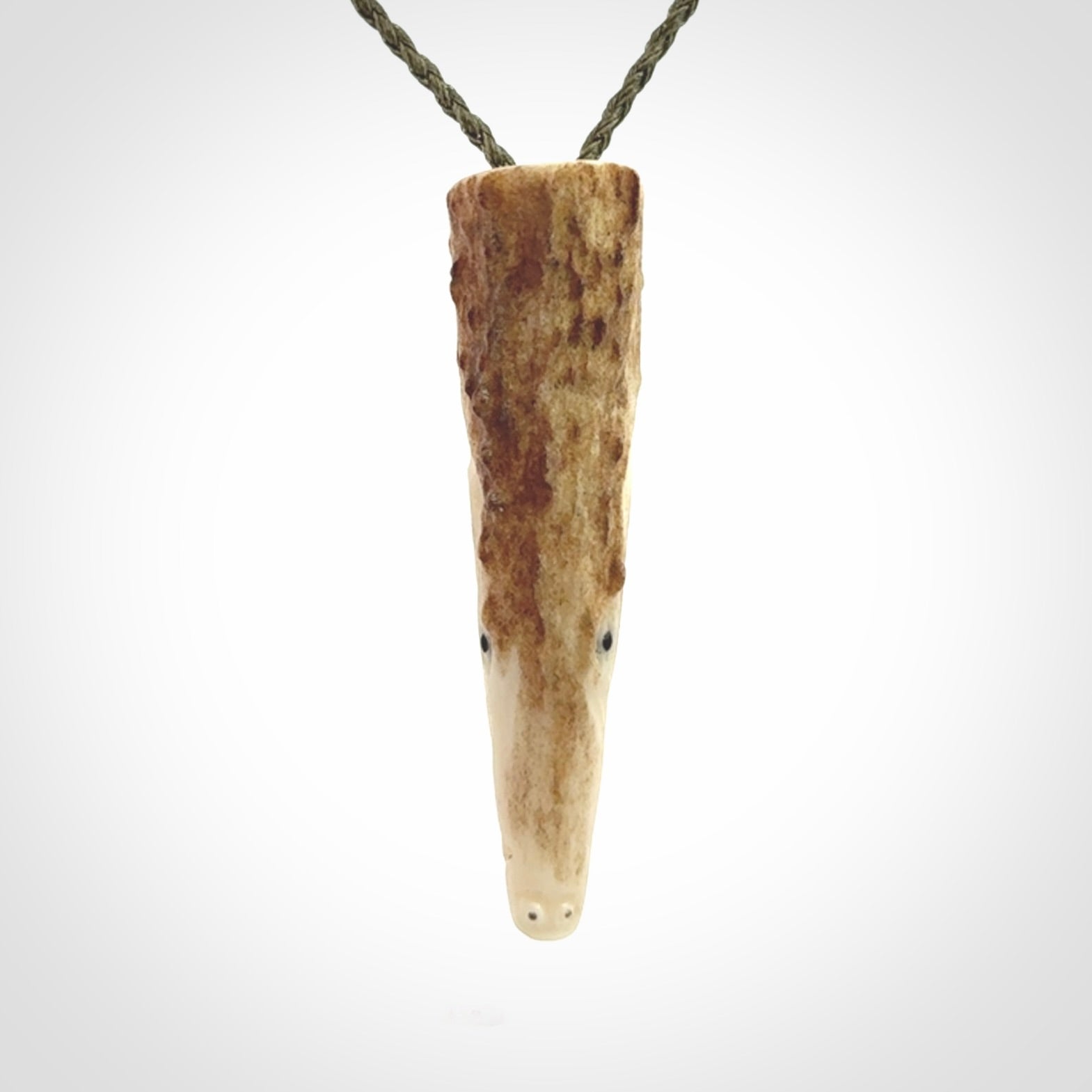 A hand carved crocodile pendant carved from a piece of deer antler. This is a work of art carved by Fumio Noguchi who is renowned for his skill in bone carving.
