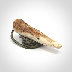 A hand carved crocodile pendant carved from a piece of deer antler. This is a work of art carved by Fumio Noguchi who is renowned for his skill in bone carving.