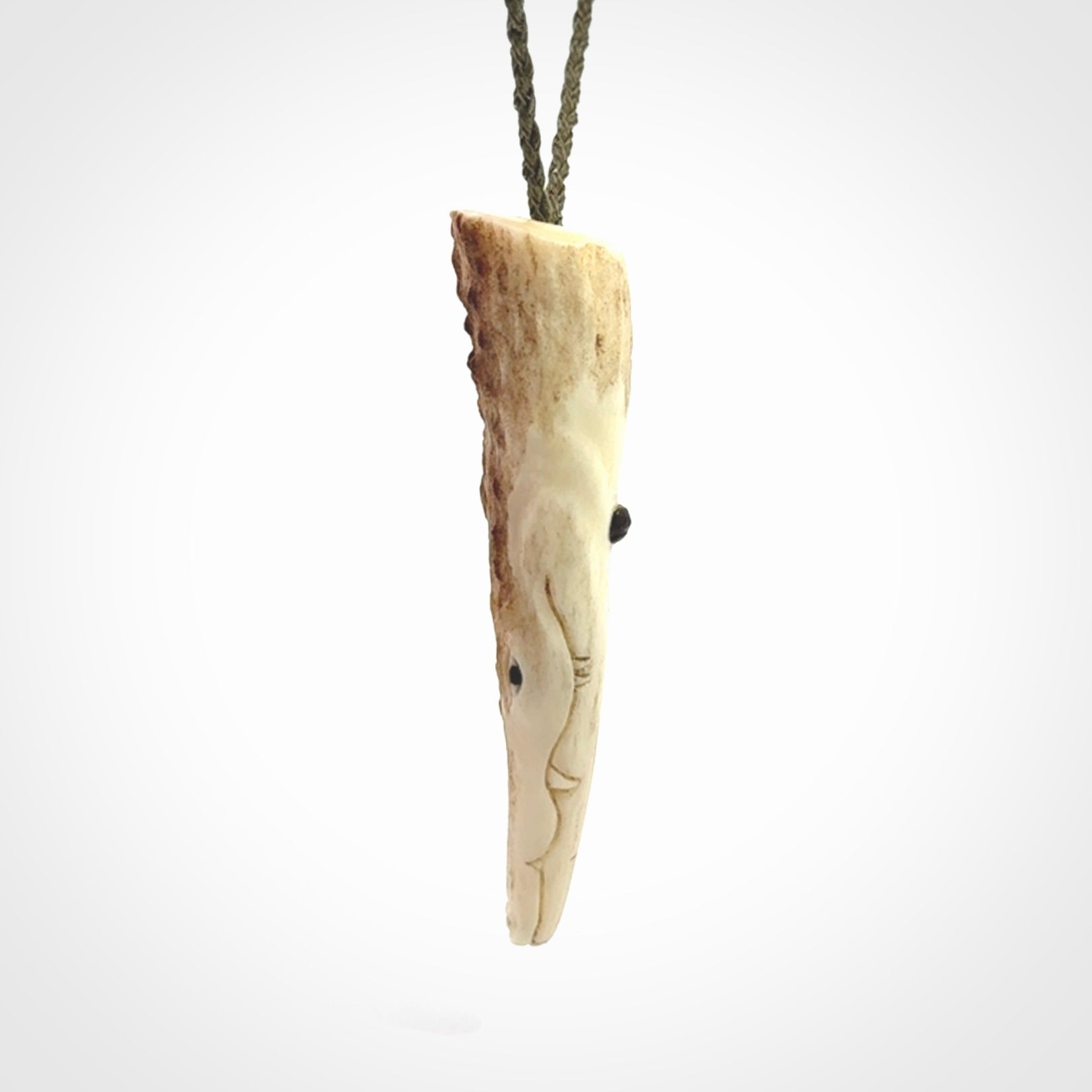 A hand carved crocodile pendant carved from a piece of deer antler. This is a work of art carved by Fumio Noguchi who is renowned for his skill in bone carving.
