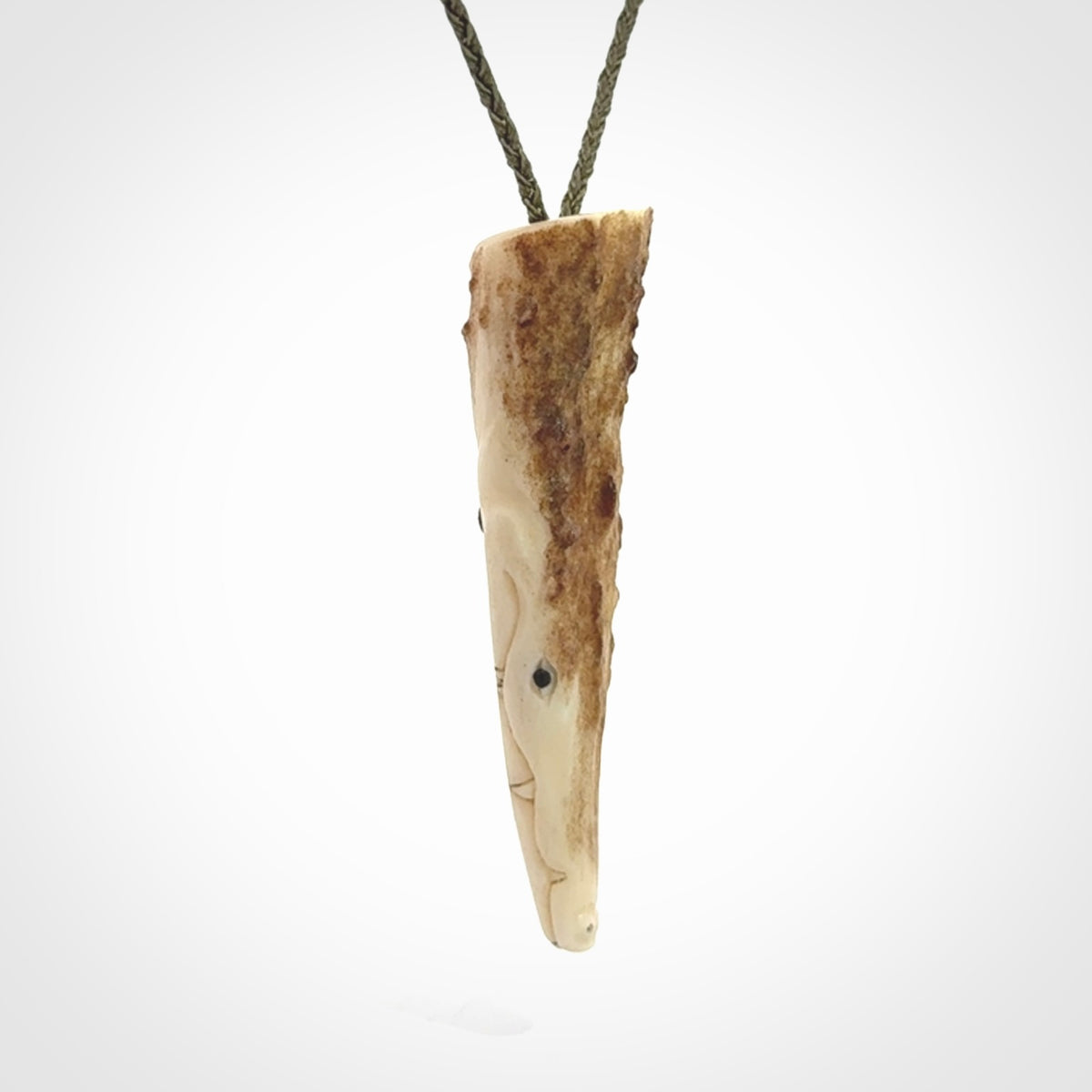 A hand carved crocodile pendant carved from a piece of deer antler. This is a work of art carved by Fumio Noguchi who is renowned for his skill in bone carving.