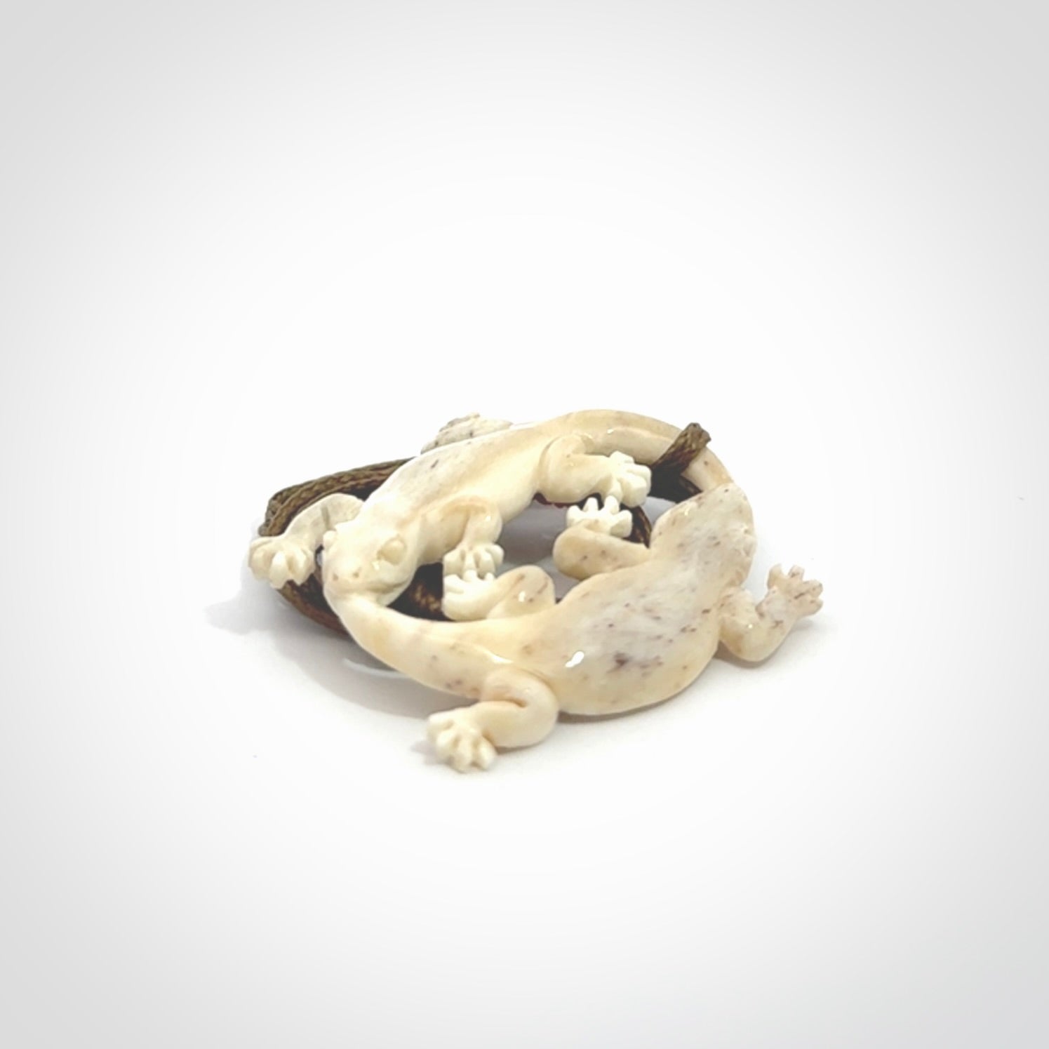 Hand carved bone double lizard pendant.