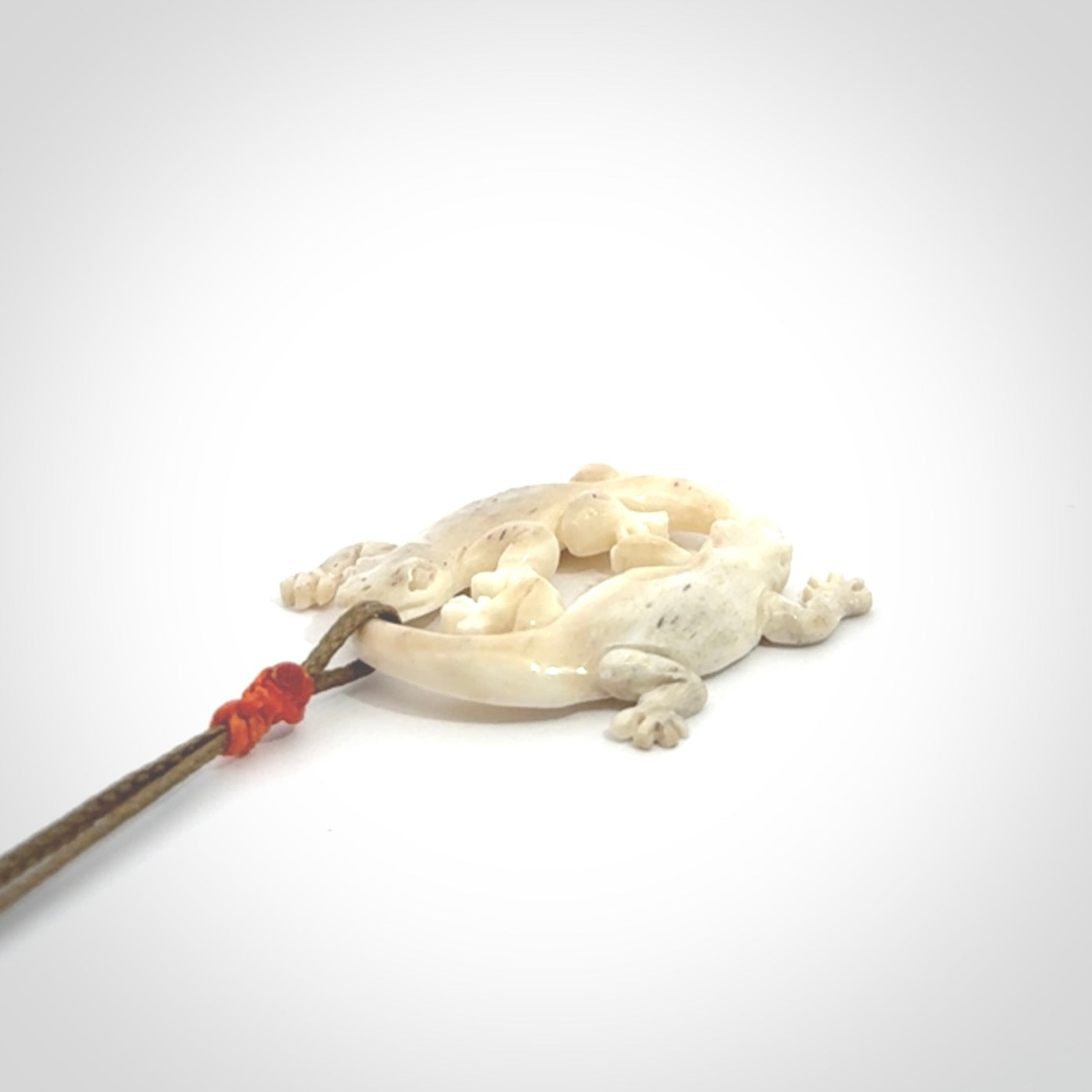 Hand carved bone double lizard pendant.